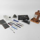 A collection of items to include pens, a desk stand,