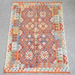 A woollen kelim rug, with two rows of diamond pattern,