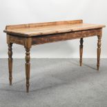 A rustic pine serving table, on turned legs,