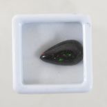 An unmounted natural black opal,