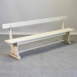 A cream painted child's bench,