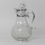 A plated and etched glass claret jug, surmounted by a lion,