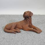 A rusted iron model of a gun dog,