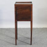 A George III mahogany bedside cupboard, with a single door,