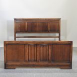 An early 20th century oak bed frame, with linenfold decoration,