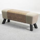 A leather and fabric upholstered pommel stool,