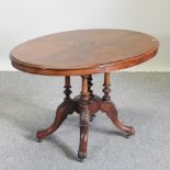 A Victorian walnut and inlaid oval breakfast table,