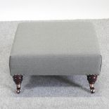 A green upholstered square footstool,