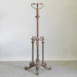 An ornate Victorian brass telescopic standard lamp, with a Corinthian column, on paw feet,