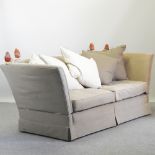 A large grey suede upholstered knole sofa, with loose cushions,