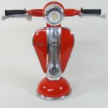 A modern lamp, in the form of a red scooter,