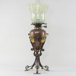An Arts and Crafts brass and copper oil lamp, in the manner of WAS Benson, on acanthus supports,