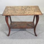 An Arts and Crafts carved 'Three Wise Monkeys' centre table, imported by Liberty and Co,