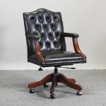 A green upholstered button back swivel desk chair