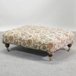 A Multiyork beige and floral upholstered stool, on castors,