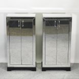 A pair of mirrored side cabinets, each enclosed by a pair of mirrored doors,