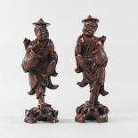 A pair of carved hardwood Japanese figures,