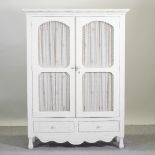 A Laura Ashley white painted glazed cupboard, with drawers below,