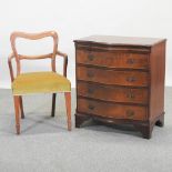 A Victorian kidney back armchair, together with an early 20th century bow front chest of drawers,