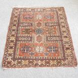 A Turkish woollen rug, with three rows of medallions and geometric design, on a red ground,