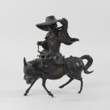 A bronze figure of a Chinese man on a mule,