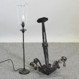 A black painted wrought iron ceiling light, with scrolled decoration,