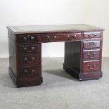 A Victorian mahogany pedestal desk, with a green inset writing surface,