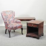 A floral upholstered armchair, together with a reproduction coffee table and a bedside cabinet,