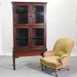 An early 20th century glazed bookcase on stand, 95cm,