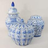 An oriental blue and white ginger jar and cover, together with another, and a vase and cover,