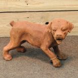 A rusted cast iron figure of a puppy,