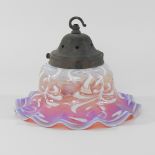 An early 20th century cranberry and vaseline glass light shade, of frilled shape,