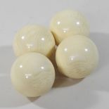 A collection of four turned bone snooker balls
