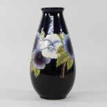 A Moorcroft style blue glazed vase,