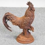 A rusted metal model of a cockerel,