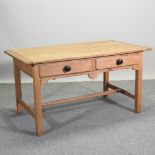 A Victorian pine kitchen table, with a plank top and two drawers, on square legs,
