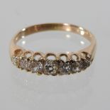 A seven stone diamond half hoop eternity ring, set with a row of graduated stones, approximately 1.