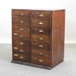 An early 20th century oak bank of drawers,