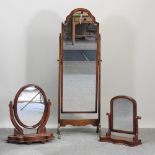 A Victorian swing frame toiletry mirror, together with another and a cheval mirror,