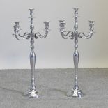 A pair of plated table candelabra,