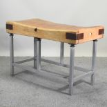A large butcher's block, on a metal stand, dated 1982,