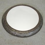 An industrial style metal framed circular wall mirror,