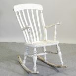 A white painted splat back rocking chair