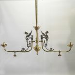 A brass double ceiling light, with Egyptian style decoration,