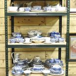 Three shelves of Staffordshire blue and white dinner wares,