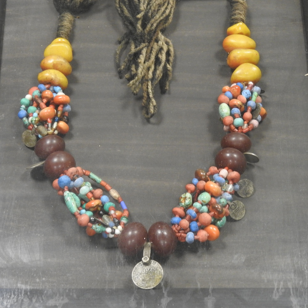 A North African copal amber and coloured bead necklace, in a glazed display frame, - Image 4 of 7
