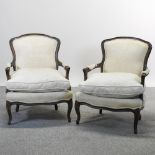 A pair of early 20th century French style cream upholstered show frame armchairs