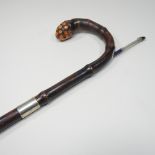 An early 20th century patent wooden walking cane, with a silver collar,