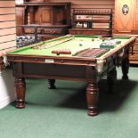 An early 20th century three-quarter size snooker table, with a slate bed, on turned legs,