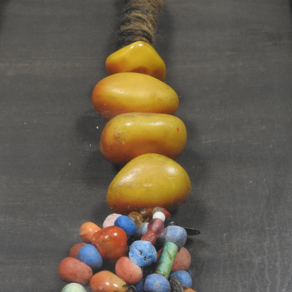 A North African copal amber and coloured bead necklace, in a glazed display frame, - Image 7 of 7